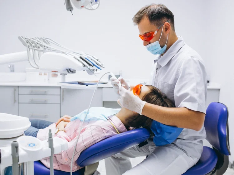 Dentist examining a damaged tooth after a lost filling or crown